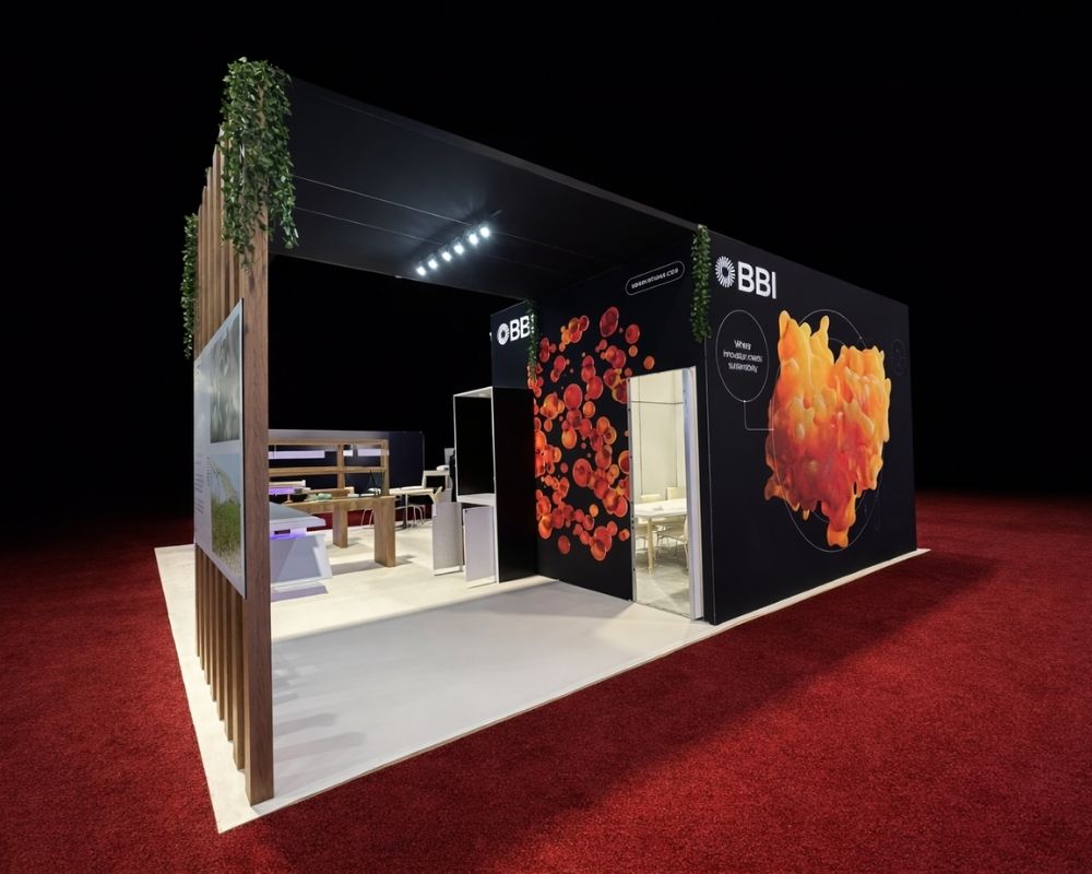BBI trade show booth with black graphic walls, organic product visuals, wood slat accents, and semi-enclosed meeting space