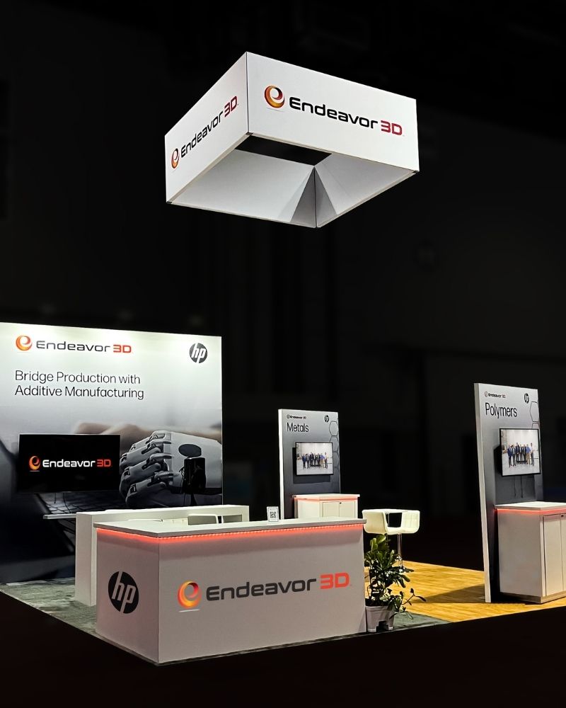 Endeavor 3D custom trade show booth with branded signage and display counters by Local Exhibits