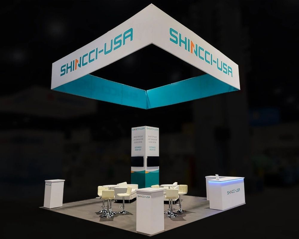 Shincci USA trade show booth with overhead hanging sign and meeting area by Local Exhibits