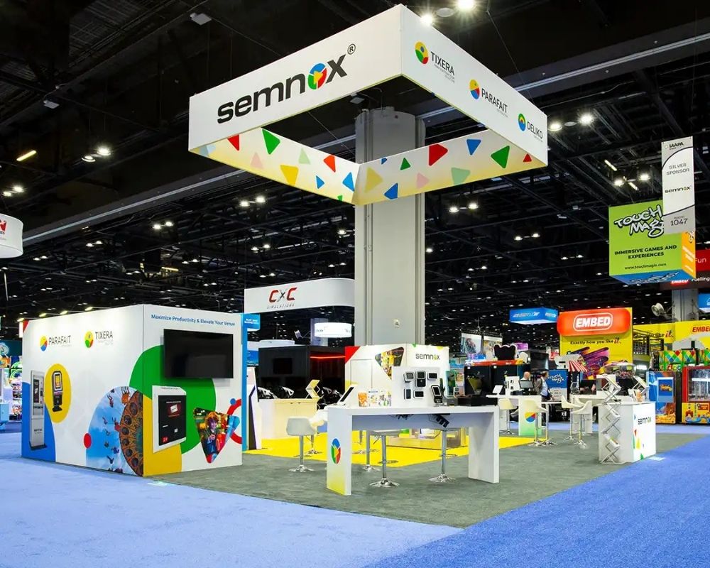 Custom trade show booth design with suspended overhead branding by Local Exhibits