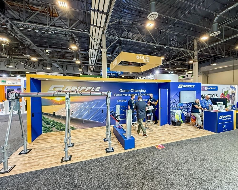 Custom trade show booth design with large branded wall and product display by Local Exhibits