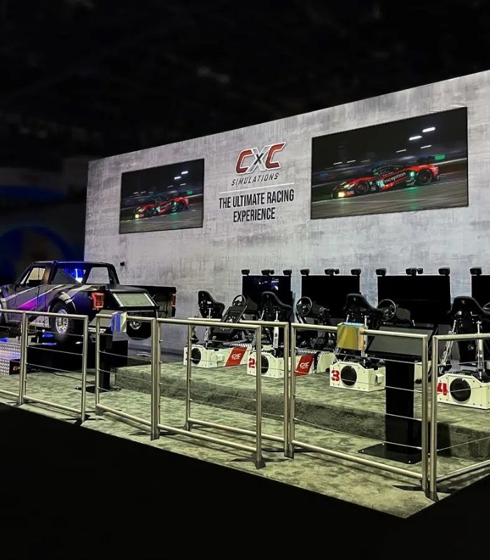 Interactive racing simulator trade show booth with multiple driving stations by Local Exhibits