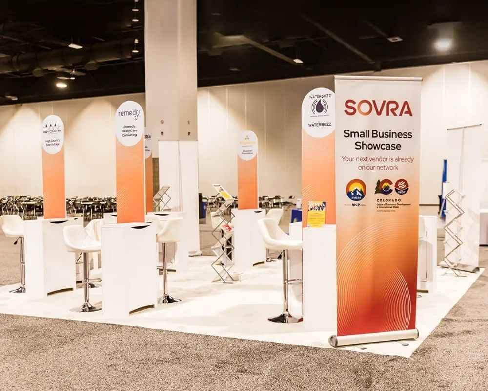 Custom trade show booth setup with branded display structures by Local Exhibits
