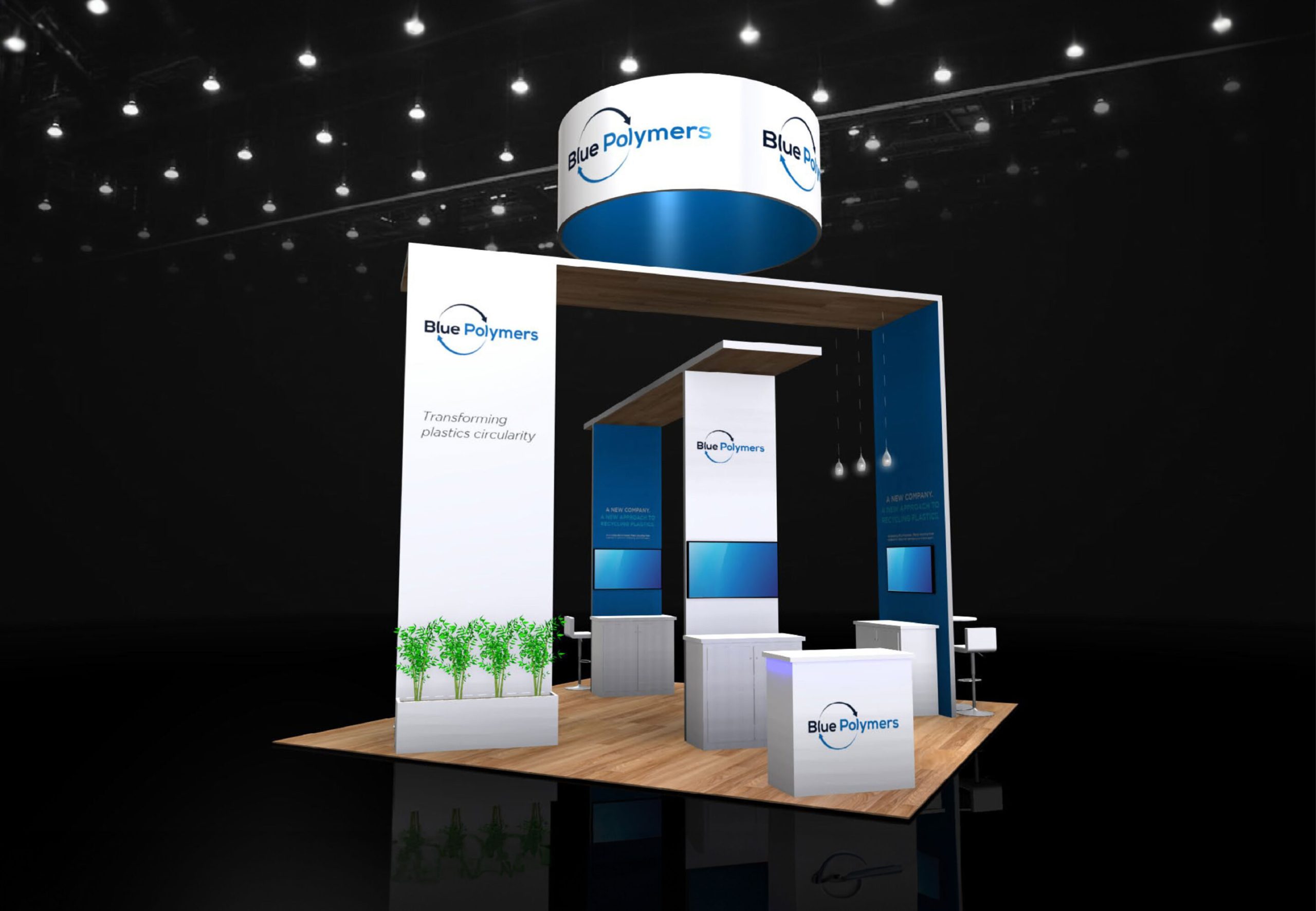 Blue Polymers trade show booth with circular hanging sign, clean white and blue structure, wood flooring, and modern product display counters
