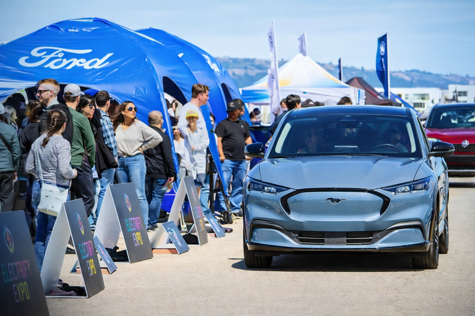 Electric vehicle display and crowd engagement at Electrify Expo event by Local Exhibits