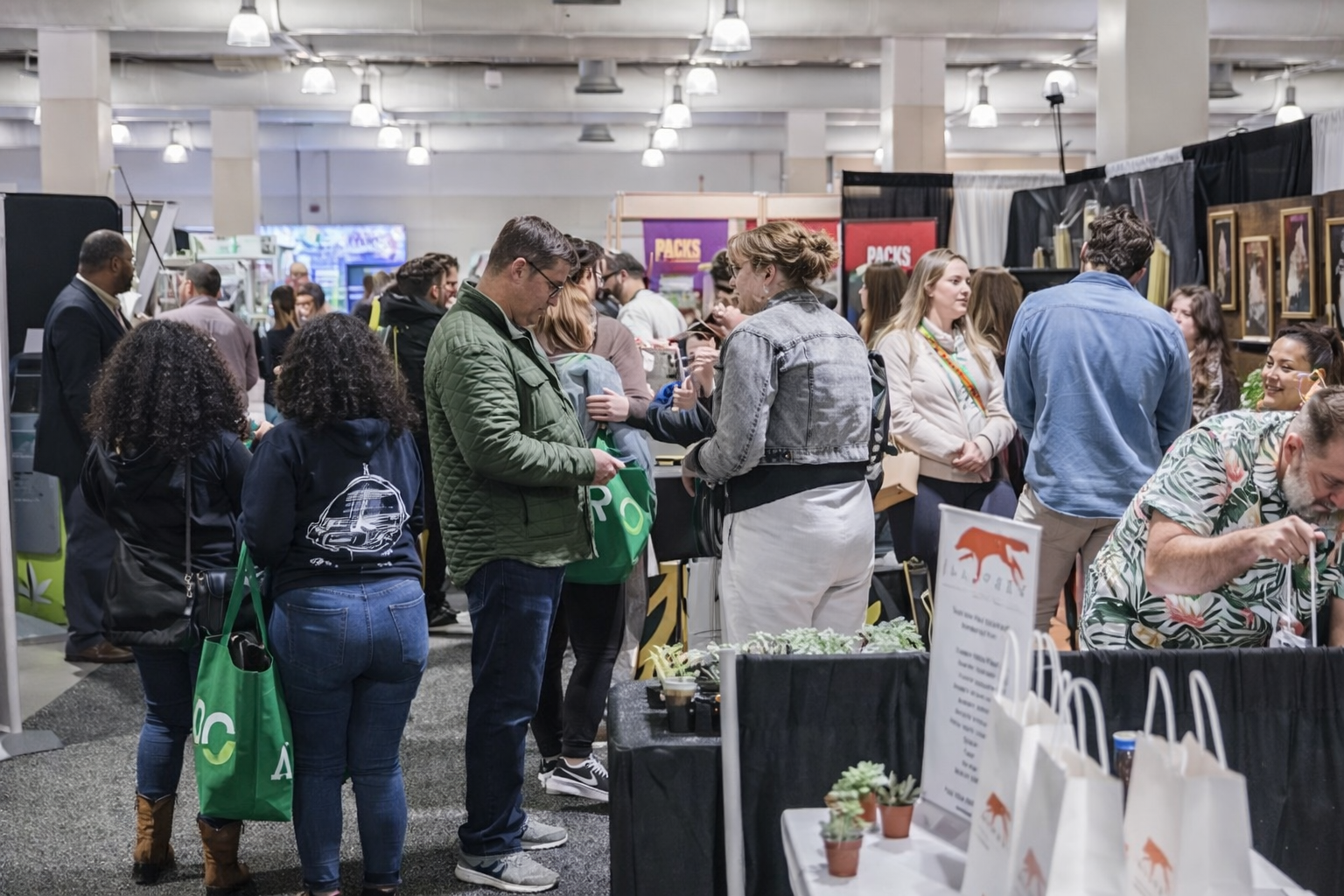 Attendees exploring exhibit booths at NECANN trade show organized by Local Exhibits