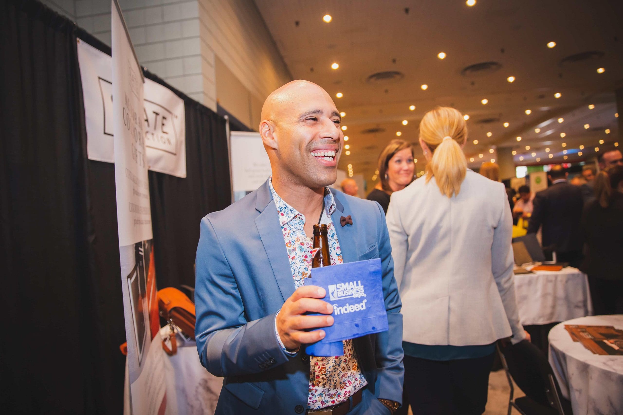 Attendee networking at Small Business Expo booth area managed by Local Exhibits