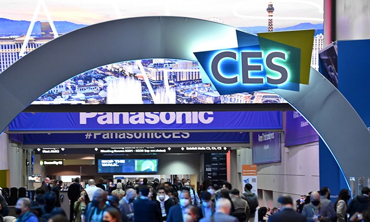 CES convention entrance with illuminated CES archway, Panasonic branding, and attendees entering the technology expo